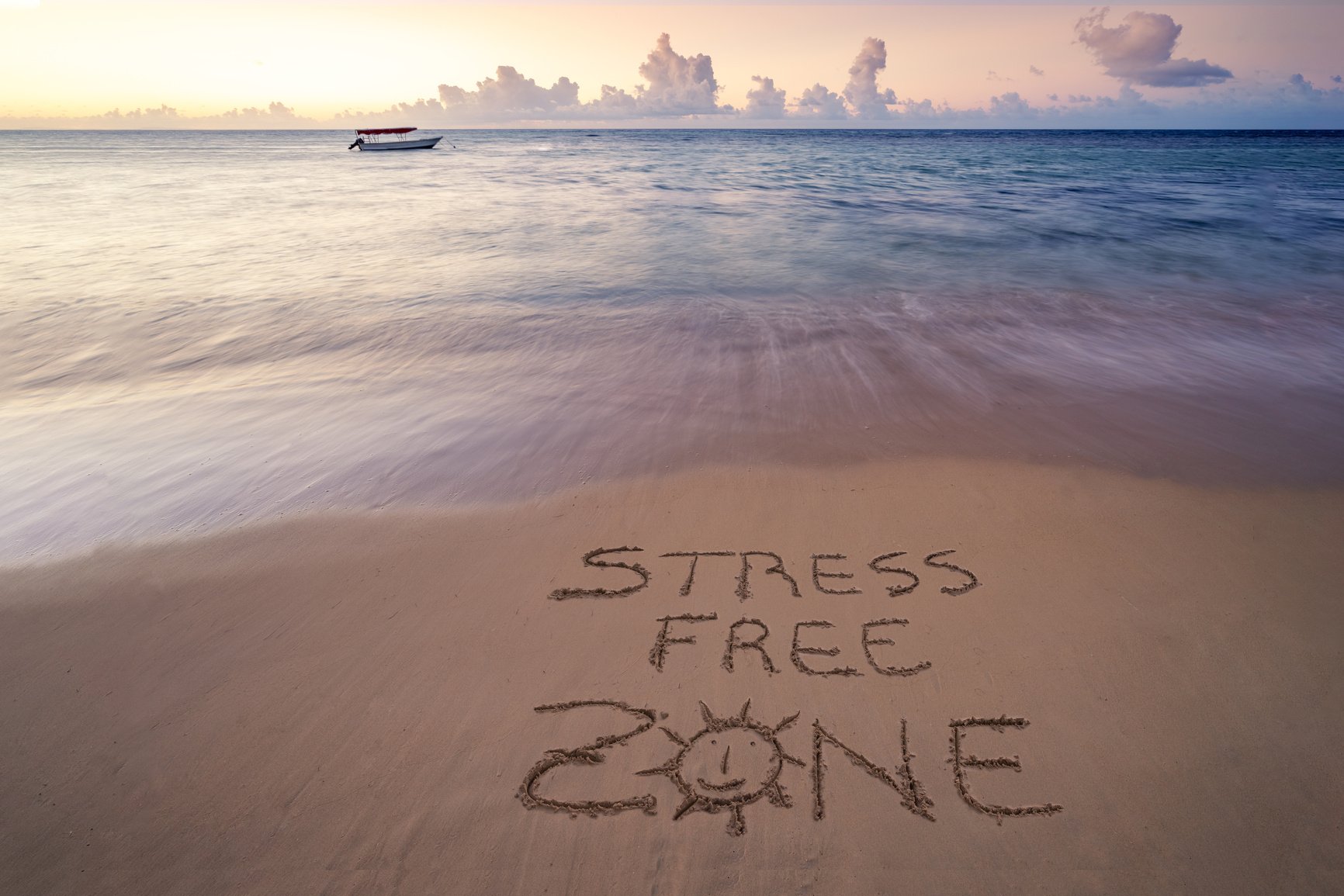 handwritten Stress free zone on sandy beach